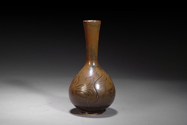 A CHINESE BROWN GLAZED VASE: This brown glazed porcelain vase has paintings of chrysanthemum flowers on the body. H: 8 1/2 in (22 cm), D: 5 in (13 cm).