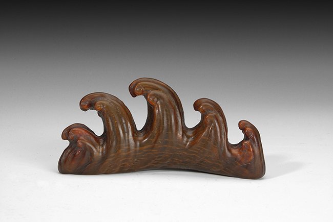 A CHINESE CARVED HORN PEN STACK: The pen holder is carved out of horn, resembling ocean wave shape. H: 2 1/2 in (6.5 cm) w 4 3/4 in (12 cm)