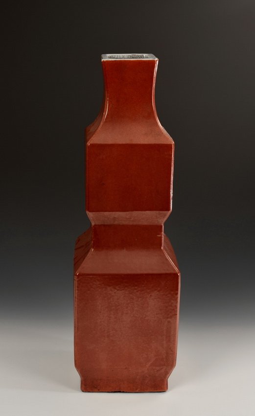 A RED GLAZED TWO SECTIONAL SQUARE VASE: A two sectional square vase covered overall with red glaze and previously drilled for table lamp. Bottom bears a four character mark. Ming Dynasty period. Dimensions: Top: 4 in (9.9 cm), Base: 6 3/4 i