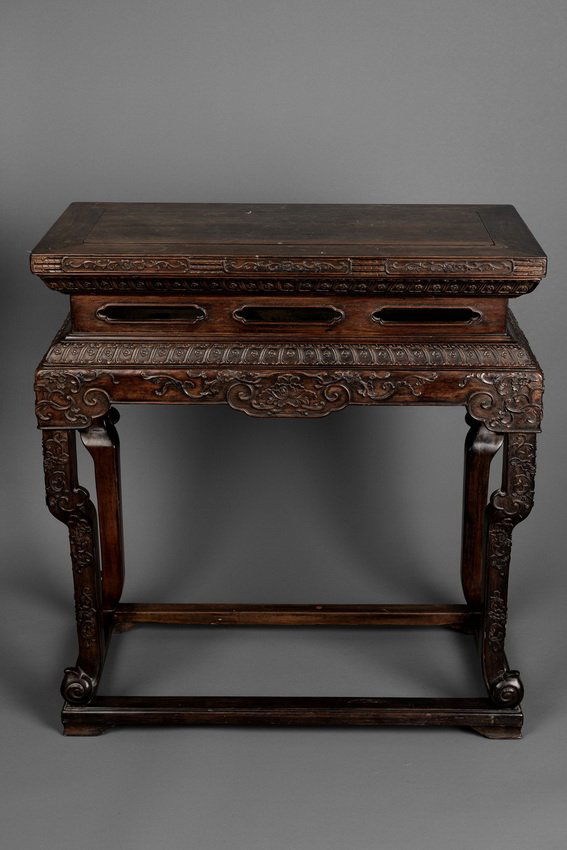 A WOOD TEA TABLE, FANGCHAJI: The single panel top set into the wide rectangular frame, above a narrow waist, carved with the design of flowering scrolls, the shaped apron with pierced Ruyi type design, and spandrels elegantly car
