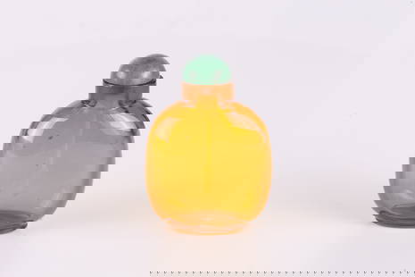 An Amber Yellow Glass Snuff Bottle: 清 琥珀黃玻璃鼻煙壺 Of flattened rounded rectangular form with a short cylindrical neck and neat oval footrim, the bottle is crafted from