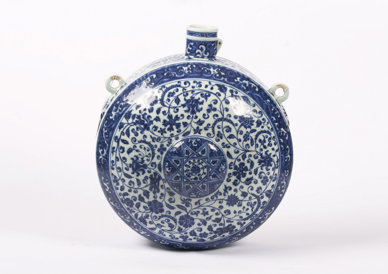 A Large Chinese Blue and White Flask, Bianhu: 或明 青花纏枝蓮雙環耳寶月瓶 Of flattened circular form with a short cylindrical neck and two strap handles at the shoulder