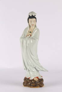 A Chinese White Glazed Guanyin Figure: &#27665;&#22283; &#26366;&#40845;&#21319;&#36896;&#27454; &#30333;&#29943;&#35264;&#38899;&#31435;&#20687; Elegantly modeled standing on swirling waves, the bodhisattva draped in flowing robes with ba