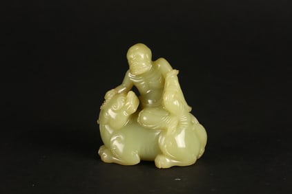 A Yellow Jade Figure of a Luohan and Bixie