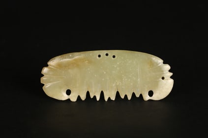 A Chinese Celadon Jade 'Teeth' Pendant