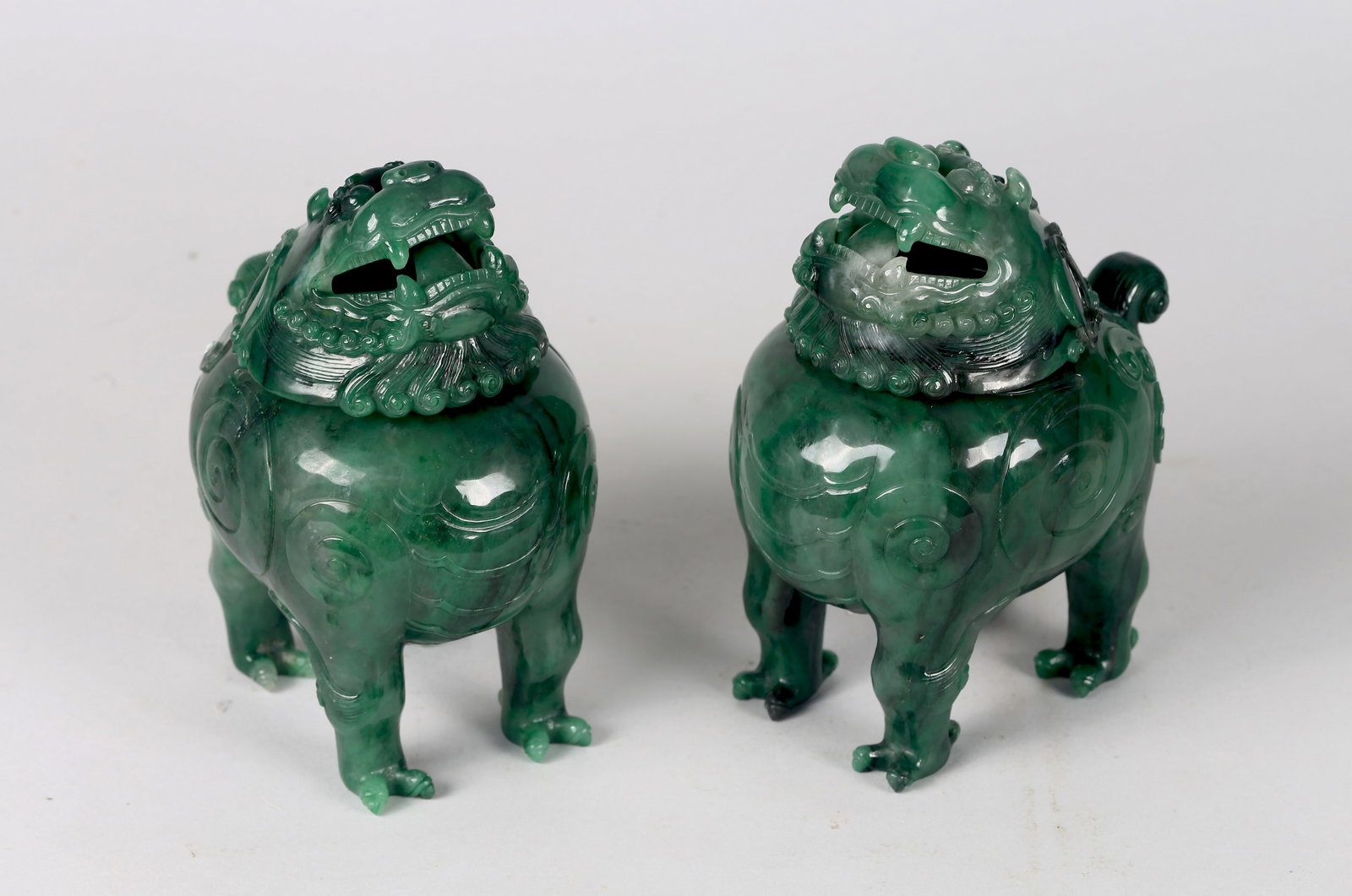 A Pair of Jadeite 'Luduan' Censers: Height: 6 1/2 in (16.5 cm) Width: 5 1/2 in (14.0 cm) 清 翠玉甪端熏爐一對 Well carved in the form of mythical beasts standing foursquare with curle