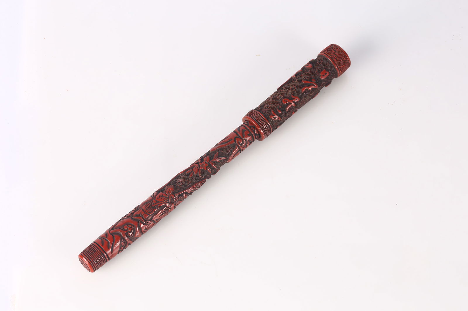 A Rare Cinnabar Lacquer 'Calligraphy and Figures' Brush: 明 剔紅庭院仕女詩文人物毛筆 Carved through layers of rich cinnabar lacquer with a continuous landscape scene of female fig