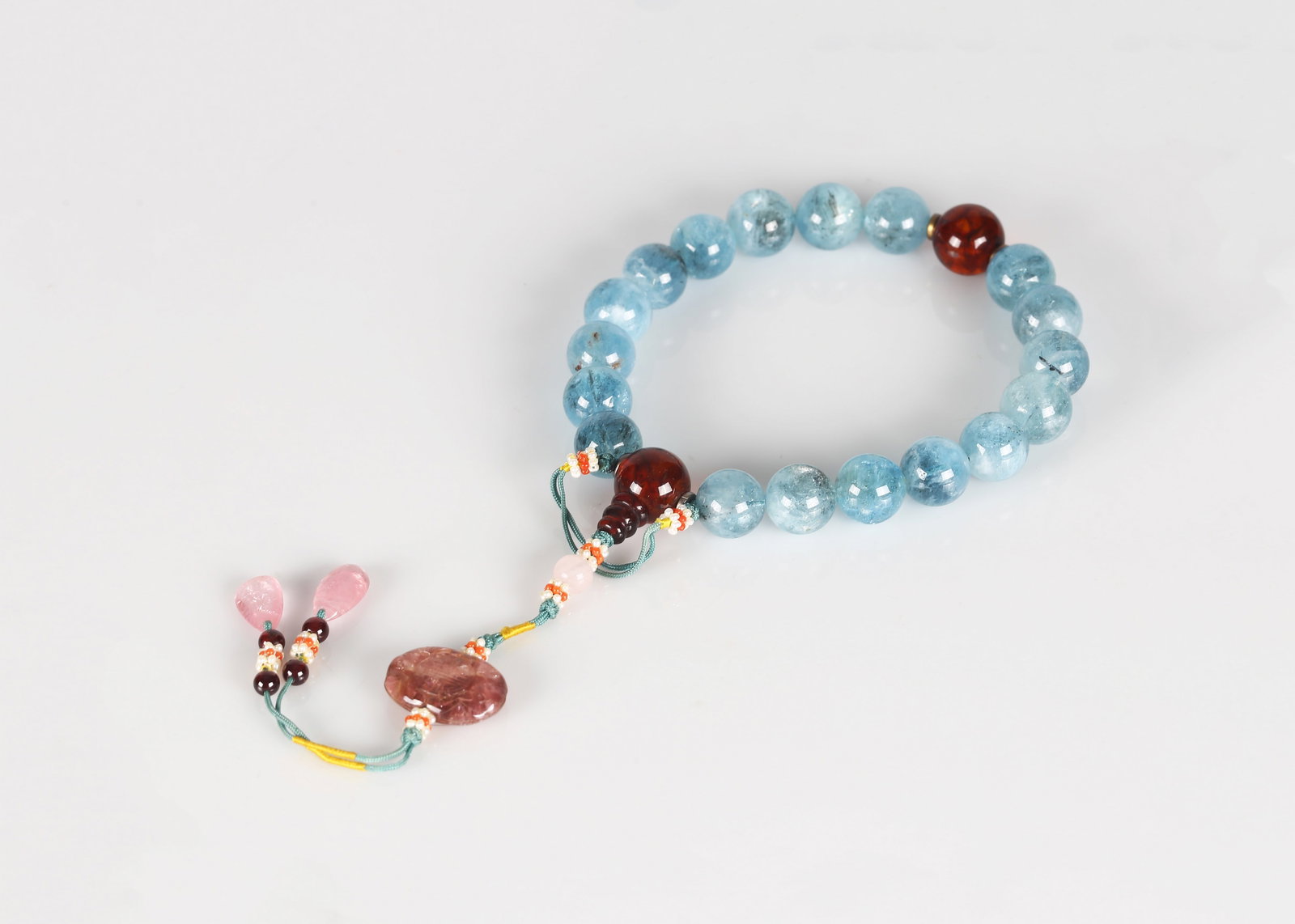 A Chinese Aquamarine Bead Rosary Bracelet: 海藍寶石十八子手串 Composed of graduated spherical aquamarine beads of translucent pale blue tone, strung as a rosary bracelet and centred by a