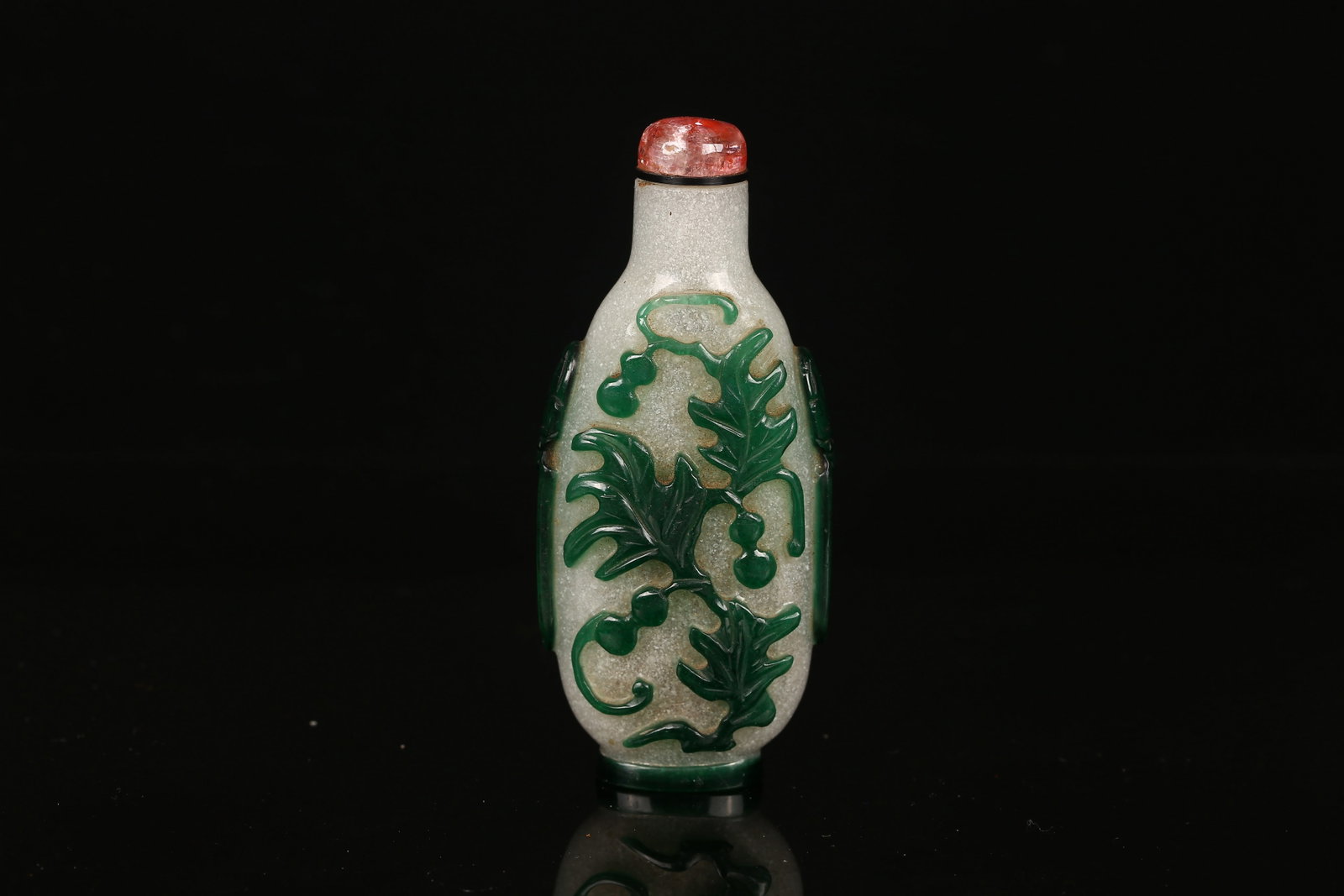 A Green Overlay 'Gourds' Glass Snuff Bottle: 清 套綠料瓜瓞圖鼻煙壺 Carved to each side through the green overlay with gourds and leafy branch. Tourmaline stopper. Qing Dynasty period.