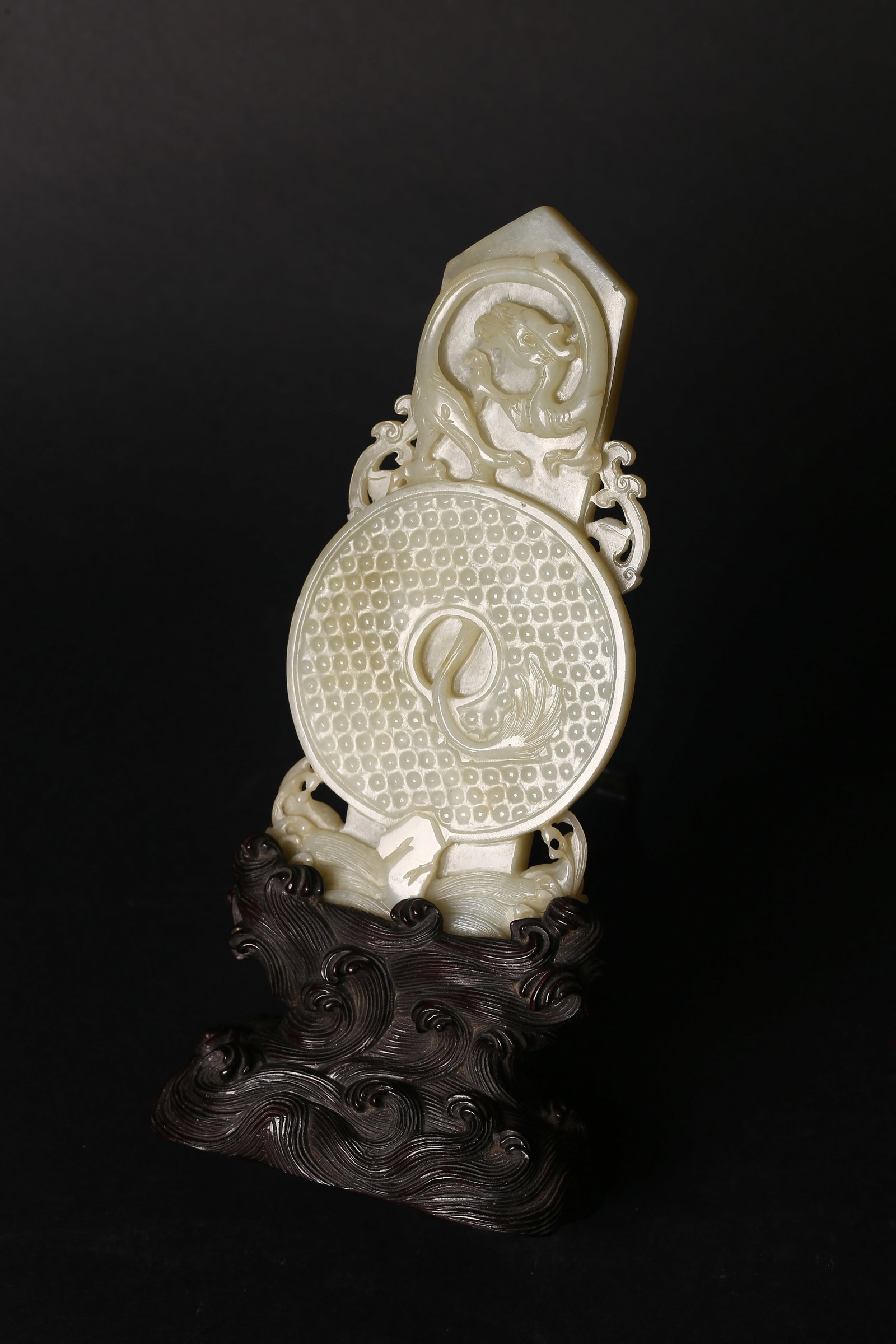 A White Jade Gui Carving of Tablet and Disc: 清 白玉十二章紋圭璧插屏 Carved in pale celadon jade with russet inclusions, the circular bi finely worked in low relief with a dense f