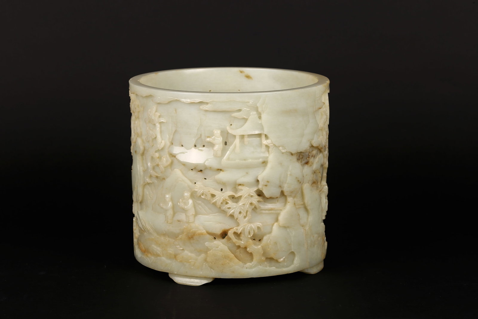 A Large Chinese White Jade 'Literati Gathering' Brushpot: 清中期 白玉雕'文會圖'大筆筒 Of cylindrical form raised on a slightly splayed foot, the stone of pale celadon-white tone with are