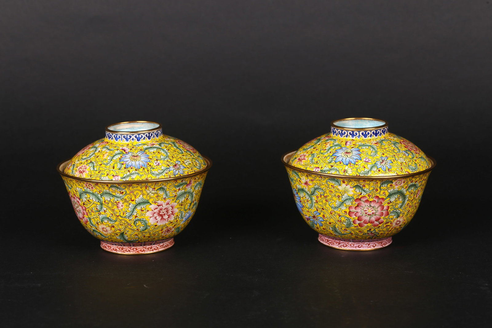 A Pair of Canton Enamel 'Flowers' Bronze Cups and Covers: 清 乾隆款 銅胎畫琺瑯纏枝花卉紋碗一對 Each bowl of flared form with deep rounded sides, matched wit
