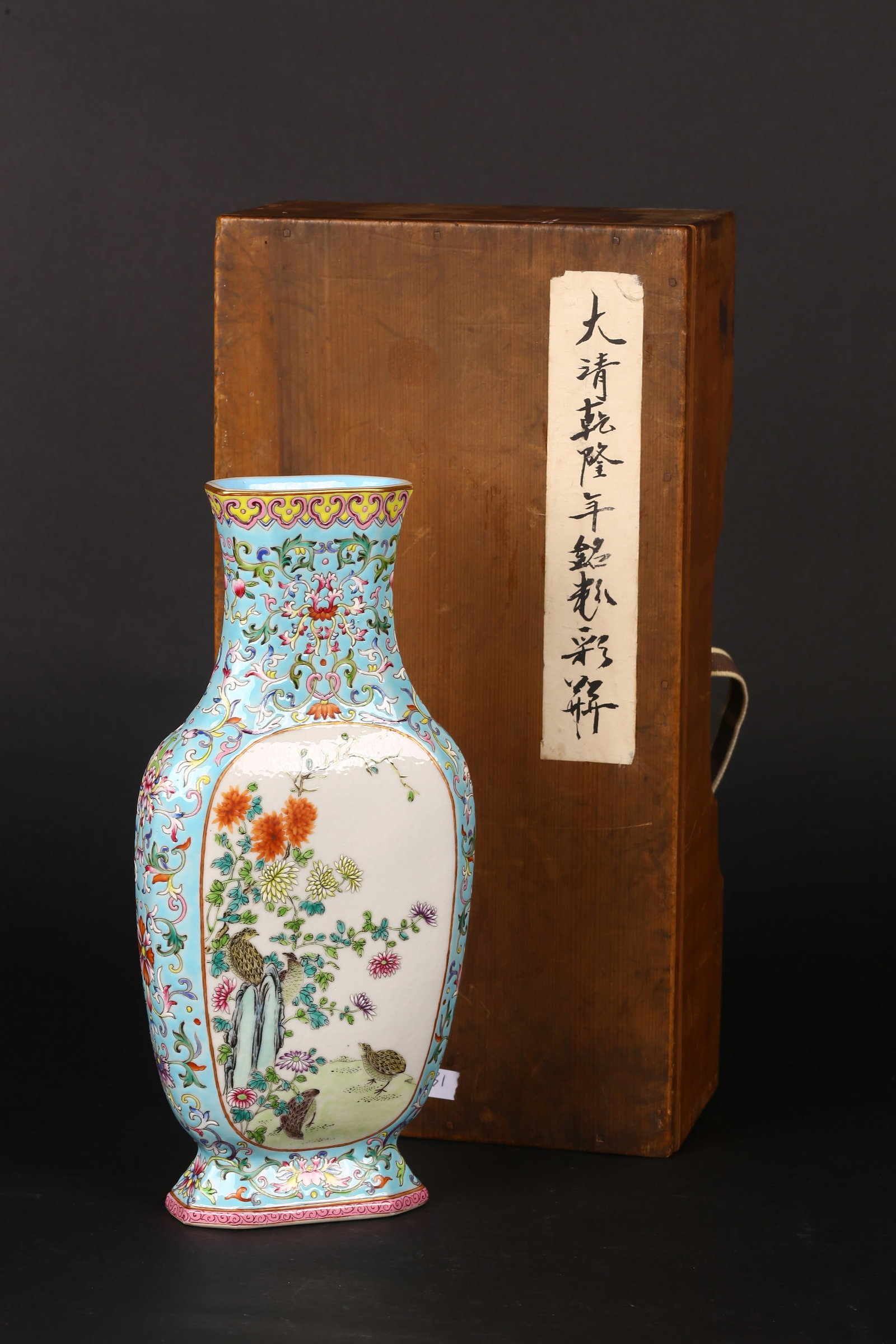 A Famille Rose 'Flowers' Flattend Vase: 清 乾隆款 粉彩詩文花卉扁瓶 帶盒 The flattened globular body rising from a short spreading foot to a narrow cylindric