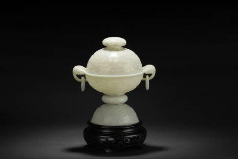 A carved white jade 'Lotus' censer with cover: Of globular form, the body tapers down to a waisted ring, with a splayed foot, the body relief carved with stylized chrysanthemum flower and vine patterns, a pair of leaf shaped handles with hanging l