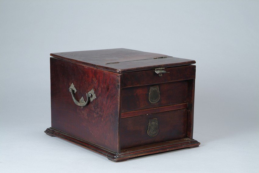 A CHINESE HARDWOOD COSMETIC BOX: The square shaped cosmetic box includes bronze handles, flip open mirror, and two drawers. H: 9 1/2 in (24 cm), W: 10 1/4 in (26 cm), L: 13 3/8 in (34 cm)