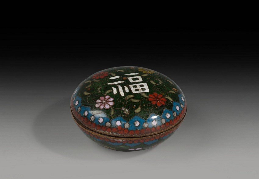 A CLOISONNE ENAMELED SEAL PASTE COVER BOX: The cloisonne enameled seal paste cover box has colorful border patterns, flowers on the top of the box, and a Chinese character 'Fu' at the center, indicating fortune. Qing Dynasty period. W: 2 1/2 i