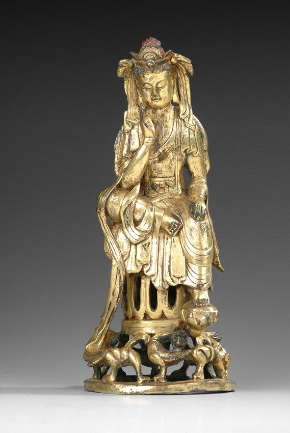 A GILT BRONZE BODHISATTVA: Finely casted, the Bodhisattva seated in Lalitasana on a high throne supported by multiple beasts, left hand on his knee, right hand close to chin, with serene expression. 18th Century. H: 7 5/8 in (1