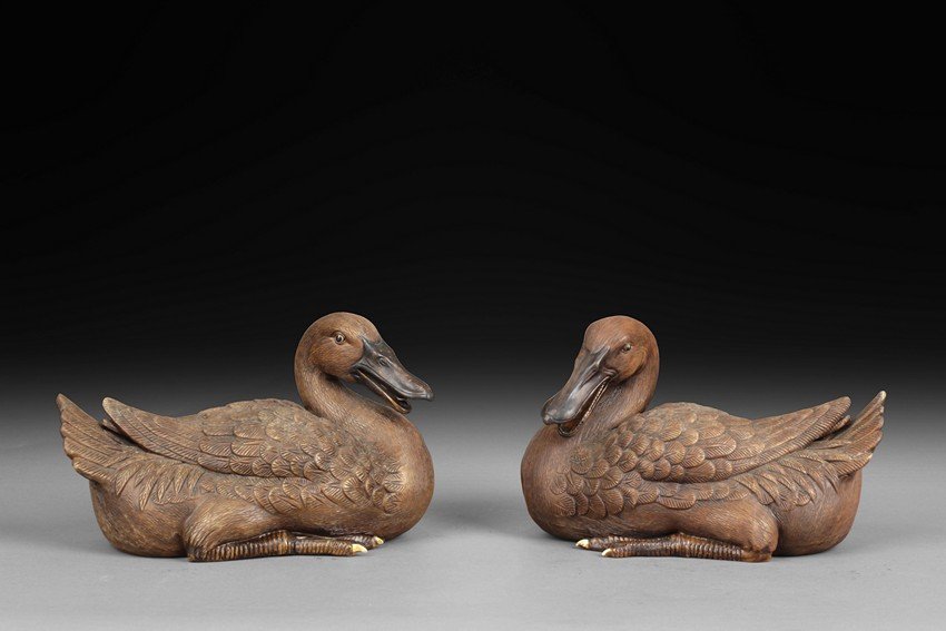 A PAIR OF ZISHA STONEWARE DUCKS: Intricately carved and detailed, the ducks were in seated position, feet and body resting directly on the ground, wings collapsed, tails up, and beaks slightly open, four characters mark on the side o