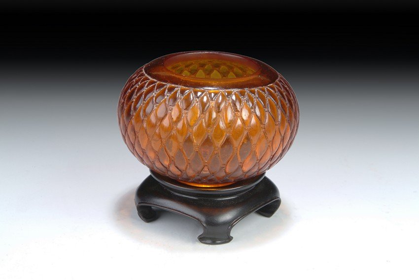 A CHINESE PEKING GLASS BRUSH WASHER: This well-made tinted brown glass water cup sits on a short foot and quickly extrudes to a wide body. A scale-like textured pattern is surrounding the body of the water cup. The mouth has a wide openi