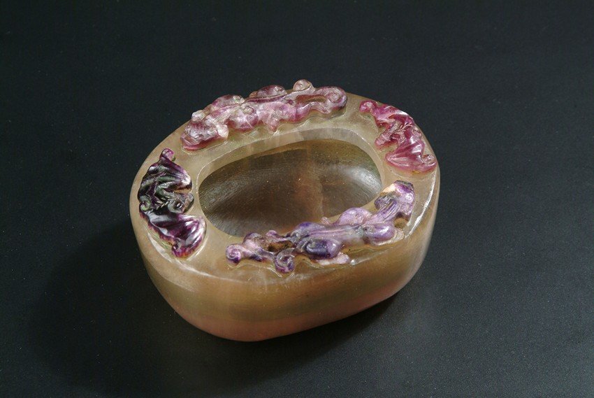 A CARVED CRYSTAL 'BATS AND CHILONG' WASHER: Of honey tone, the well hollowed washer is decorated with two bats and two Chilong on the top edge, each with different color. Qing Dynasty period. L: 4 in (10.2 cm) H: 2 1/8 in (5.4 cm)