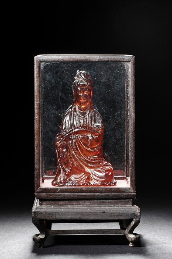 AN AMBER CARVED MODEL OF GUANYIN (1 of 5)