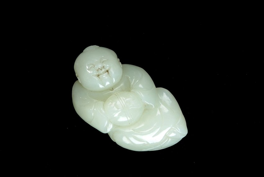 A WHITE JADE CARVED YOUNG CHILD FIGURE (1 of 3)