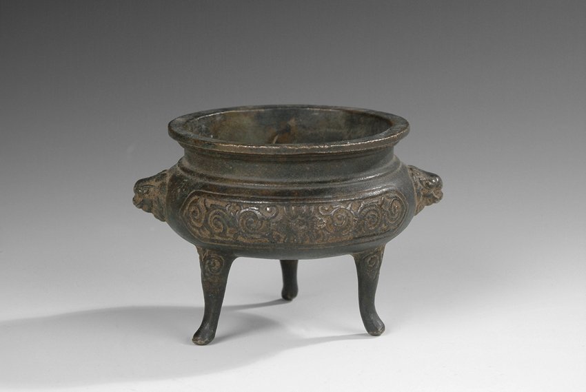 A 'XUAN' MARK TRIPOD CENSER: The bronze tripod censer of globular form, splayed round top, the body supported by three hoof legs, two lion head handles, intertwined vines patterns on the body, one Chinese character mark of 'Xuan'