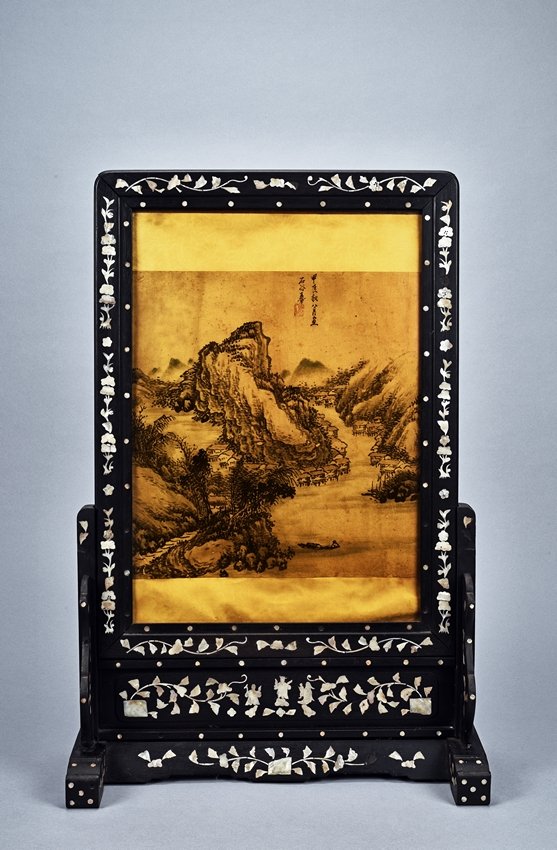 A PAINTING INLAID HONGMU MOTHER-OF-PEARL TABLE SCREEN: The table screen containing a color and ink on paper painting, with inscription and seal, attributed to Wang Hui, the table screen embellished with mother-of-pearl decoration. Qing Dynasty period. Hei