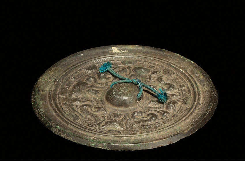 A BRONZE 'INSCRIPTIONS AND BEASTS' MIRROR (1 of 3)