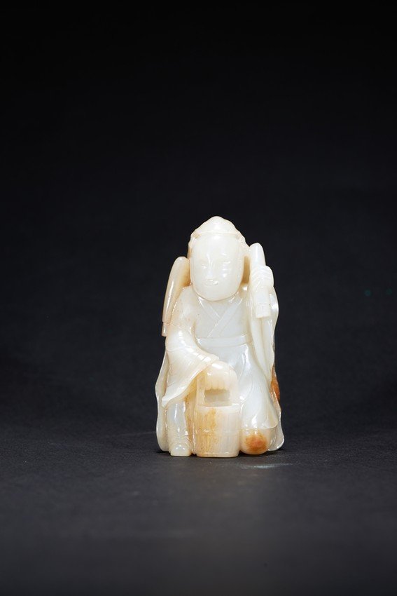 A WHITE JADE CARVED FIGURE WITH SKIN (1 of 3)
