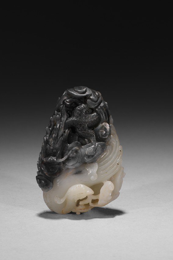 A WHITE AND BLACK JADE CARVING OF DRAGON AND PHOENIX (1 of 5)