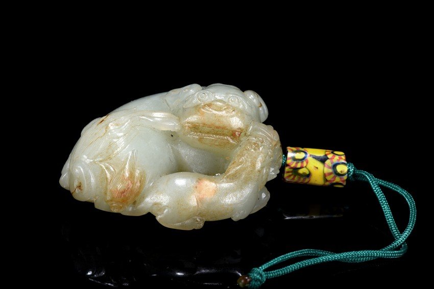 A WHITE JADE CARVING OF MYTHICAL BEAST (1 of 6)