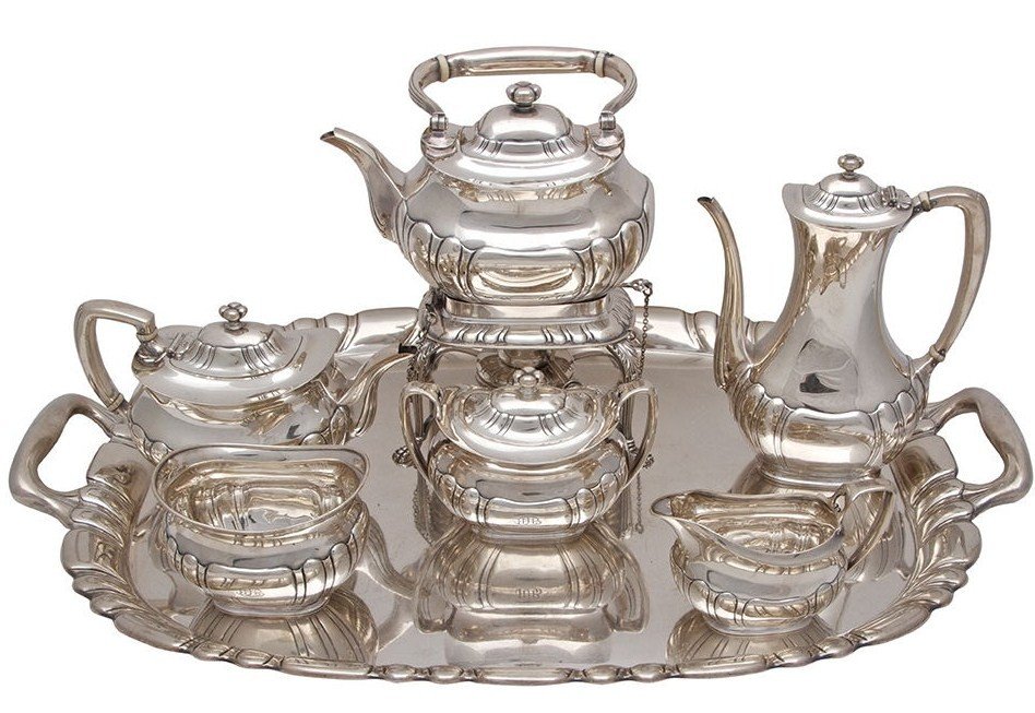 MAGNIFICENT TIFFANY & CO. STERLING SILVER TEA SET: Stunning Tiffany & Co. six-piece tea and coffee service, circa 1910. Comprising of a teapot, coffee pot, kettle on lampstand, creamer, covered sugar bowl, waste bowl and tray. The set is of a rounded