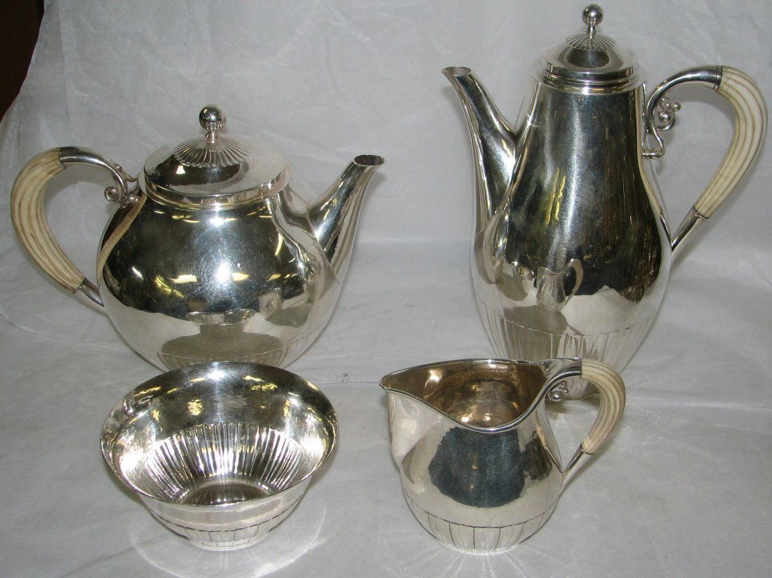 GEORG JENSEN TEA & COFFEE SERVICE # 45A: A DANISH SILVER FOUR-PIECE TEA AND COFFEE SERVICE, DESIGNED BY JOHAN ROHDE** MARK OF GEORG JENSEN, COPENHAGEN, 1925-1932 Cosmos pattern, comprising: a coffee pot, teapot, cream jug and sugar bowl; the