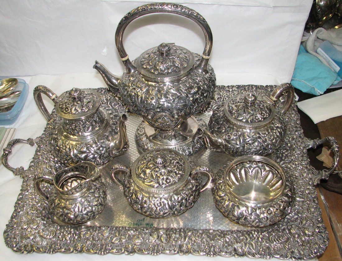 PETER KRIDER PHILA. REPOUSSE 7 PC TEA SET: PETER KRIDER STERLING SILVER TEA & COFFEE SERVICE IN THE REPOUSSE PATTERN CONSISTING OF : TILTING KETTLE ON STAND, COFFEE POT, TEAPOT, CREAMER, COVERED SUGAR BOWL, WASTE BOWL & LARGE REPOUSSE TRAY BY 