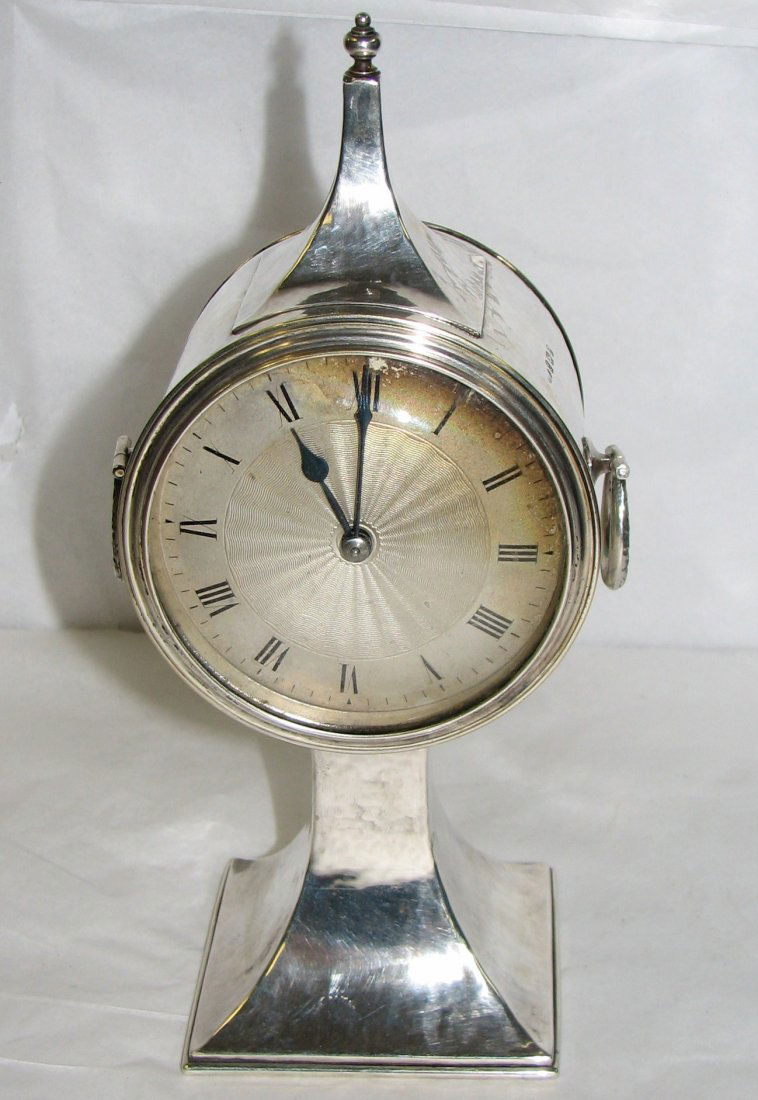 A.E. JONES ARTS & CRAFTS STERLING SILVER CLOCK: A.E. JONES ARTS & CRAFTS STERLING SILVER CLOCK WITH RING HANDLES MEASURING 9 & 1/2 INCHES IN HEIGHT FULLY MARKED AS A.E.J. ANCHOR, LION FACING LEFT & Z date letter.