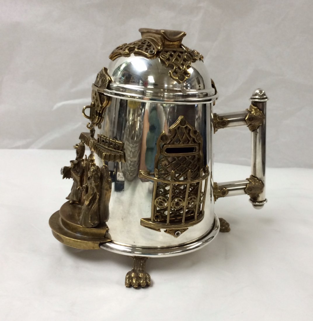 RARE JUDAICA STERLING SILVER TZEDOKAH / CHARITY BOX: JUDAIC STERLING SILVER TZEDOKAH / CHARITY BOX WITH BRASS MOUNTS IN THE STYLE OF SWED MEASURING 6 & 1/2 INCHES IN HEIGHT & 7 INCHES FROM HANDLE TO THE FRONT. THE TZEDOKAH BOX IS HALLMARKED AS SHOWN. TH