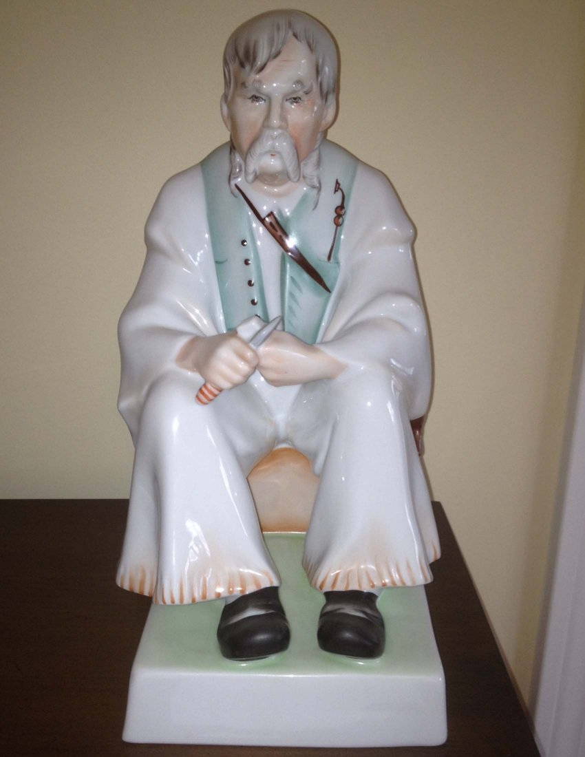 Zsolnay Figure of a Man Whitling: Zsolnay Figure of a man Whitling, height 13". From the estate of Mavis Lopater, to benefit the Hans and Mavis Lopater Foundation