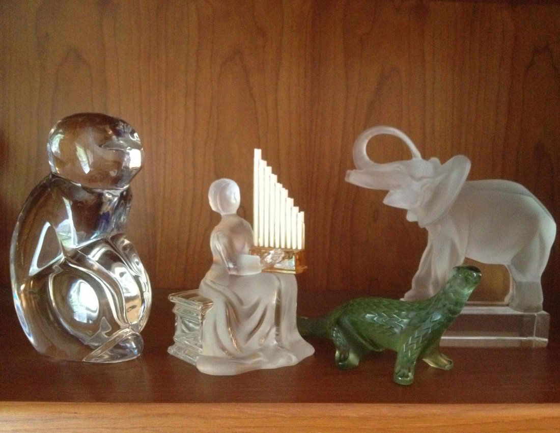 Val St Lambert, Lalique, St Louis Glass: Val St. Lambert Monkey 6 in, Saint-Louis Harp Player 5.25 in, Green Lalique Dinosaur 6 in, Lalique Elephant ht 6 in. From the estate of Mavis Lopater, to benefit the Hans and Mavis Lopater Foundation