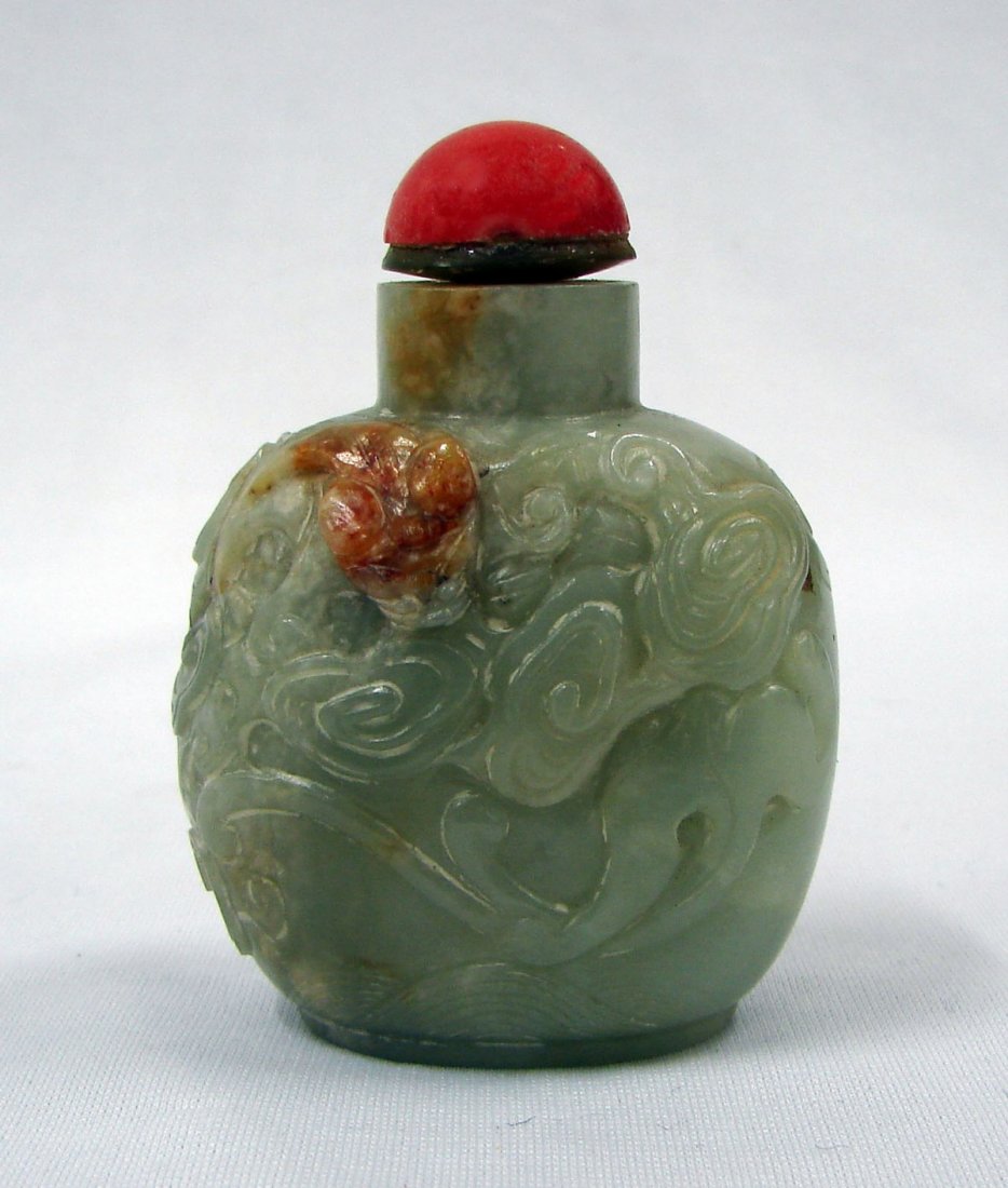 19th Century Chinese Jade Snuff Bottle: Jade snuff bottle with carved decoration and original cap measuring 3 1/4" height, 19th century, Chinese.