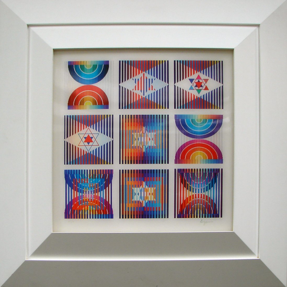 "9 Up" Agamograph by Yaacov Agam Signed Dated: This is framed with measurements of 23-3/4" high by 24" wide. The open area measures 13-3/4" high by 13-1/2" wide. The piece is signed and dated on the lower right. The number is "38/99" and appears o