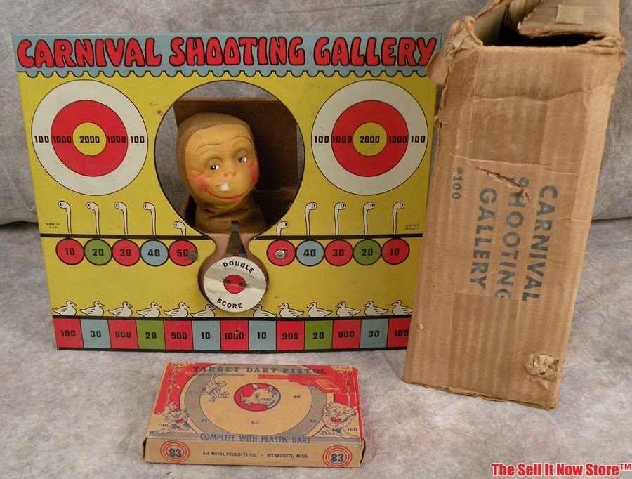 Circus Shooting Gallery Dart Pistol Gun Toy: This is a tin lithograph Circus Shooting Gallery that features a round bulls eye attached to a wood box. When the target is hit a monkey springs from the box. The display is 11-9/16" tall by 13-1/2" w