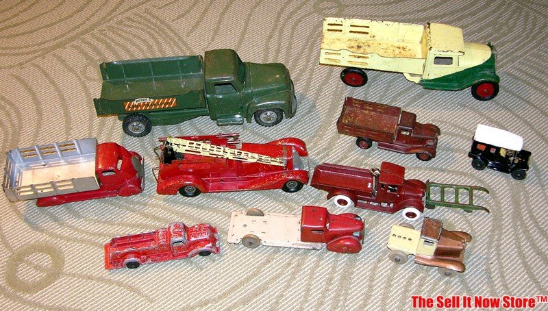 Antique Pressed Tin Toy Trucks Buddy L, others: This is a large lot of 10 antique pressed tin toys from Buddy L and others. These are being auctioned as one lot and the condition varies. They have all been well used. To view more detailed photos of