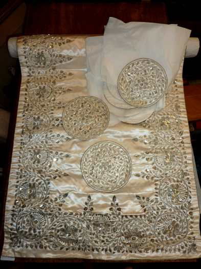 Large silkwork rectangular centered table cover wi: Large silkwork rectangular centered table cover with silver, wire, bullion and floral detail and a set of 12 matching circular place settings.