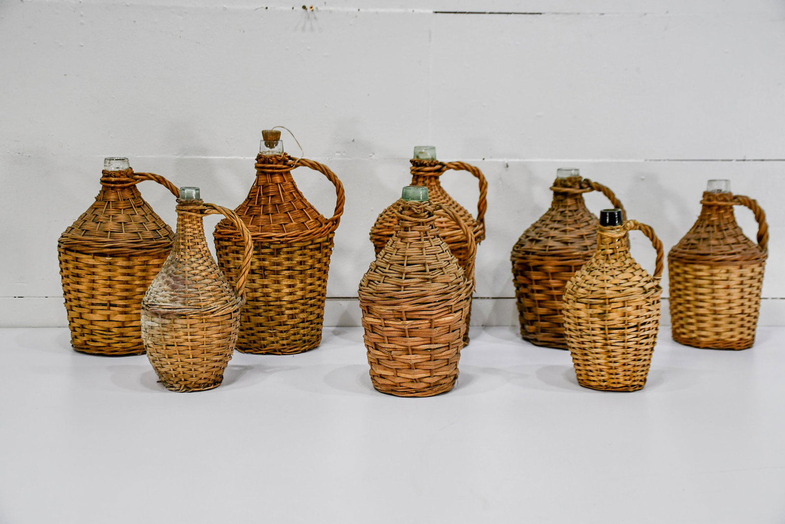 8pc. Lot of Wicker Wrapped Bottles biggest  -   17"H, (1 of 2)