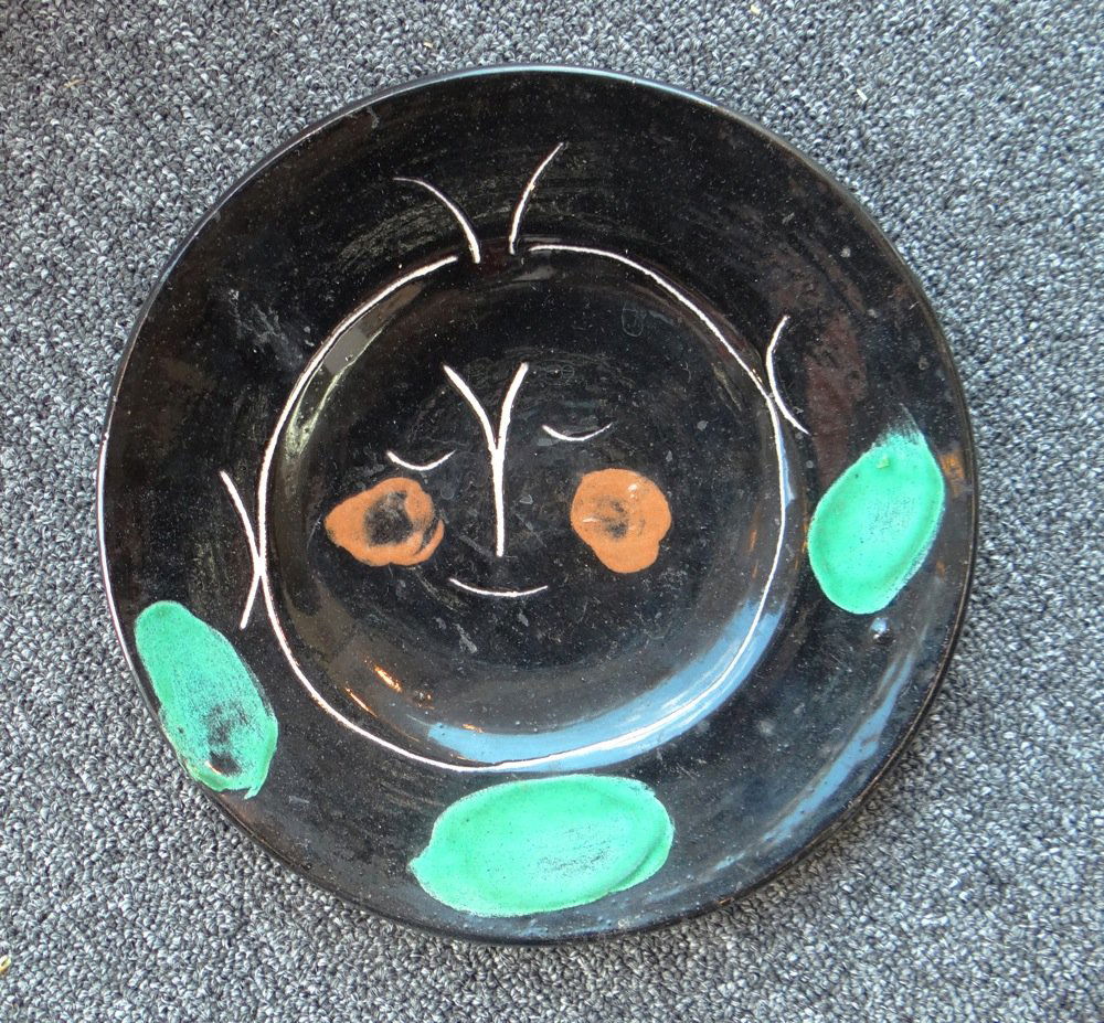 Pablo Picasso Madoura ceramic plate: Artist: Pablo Picasso Title: Plate A Suite: Service Visage Noir Medium: Turned round plate in A.R. white earthenware clay, decorated with slips and knife engraving in green, red, white and black gloss