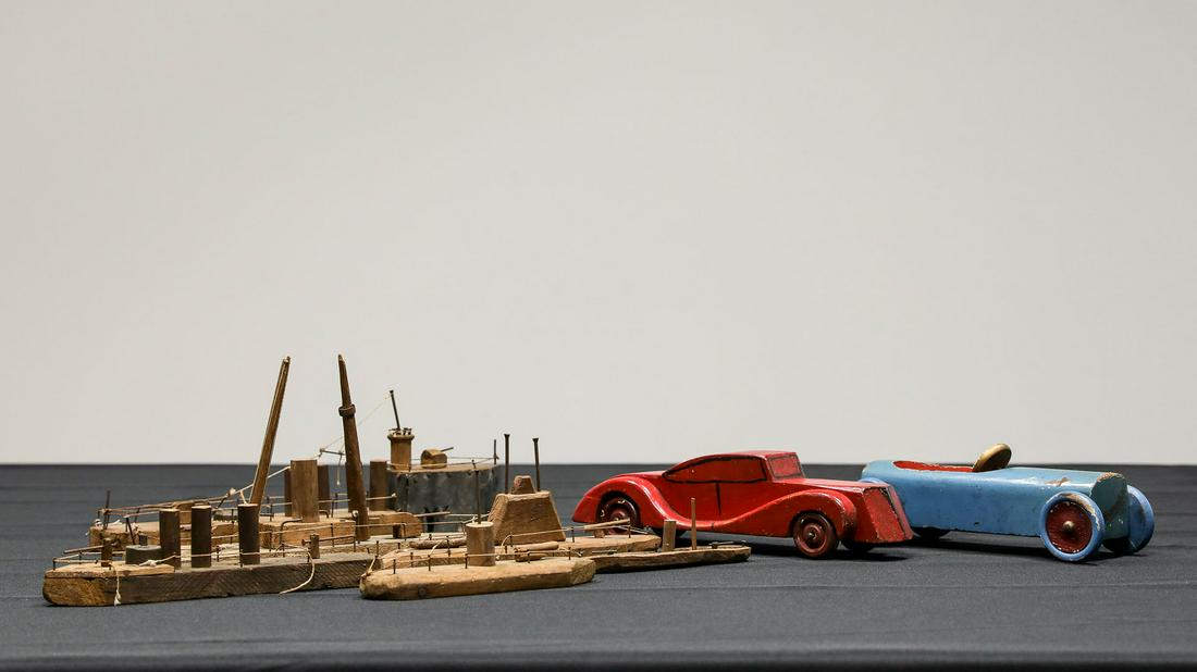 Collection of Small Wood Toys: Collection of Small Wood Toys - Offered Without ReserveCollection of six small boats in natural wood of various designs and two painted roadster style cars, lot of 8.