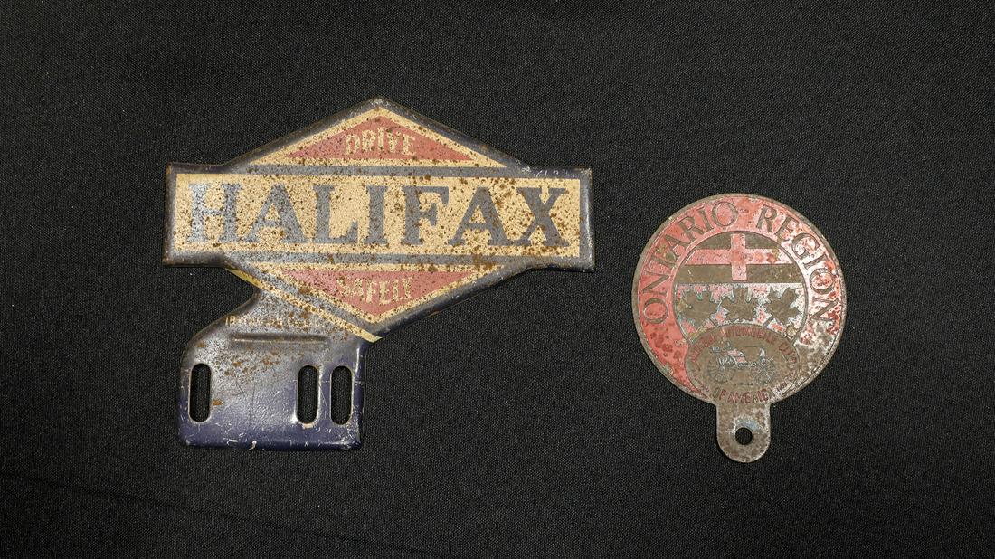 Two Canadian License Plate Toppers: Two Canadian License Plate Toppers - Offered Without Reserve1950s Ontario Region AACA Members Badge/Topper, red enamel on stamped copper plate, 3.25” W x 4” H; â€œDrive Halifax Safely&