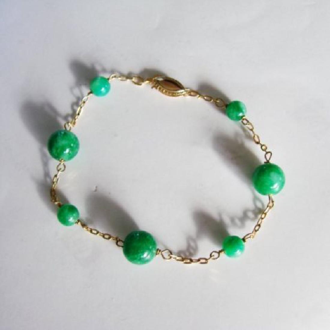 Natural Jadeite Jade Bacelet 18k Y/g Filled: Gems Type: Natural Jadeite Jade Total Weight:4.25grams 7 Pieces Jade Round Bead Measurement:6x9mm Grade A,Color:Green Origin: Beijing China (Mainland) Length: 8" 18k Yellow Gold Filled Weight:1.85 gra