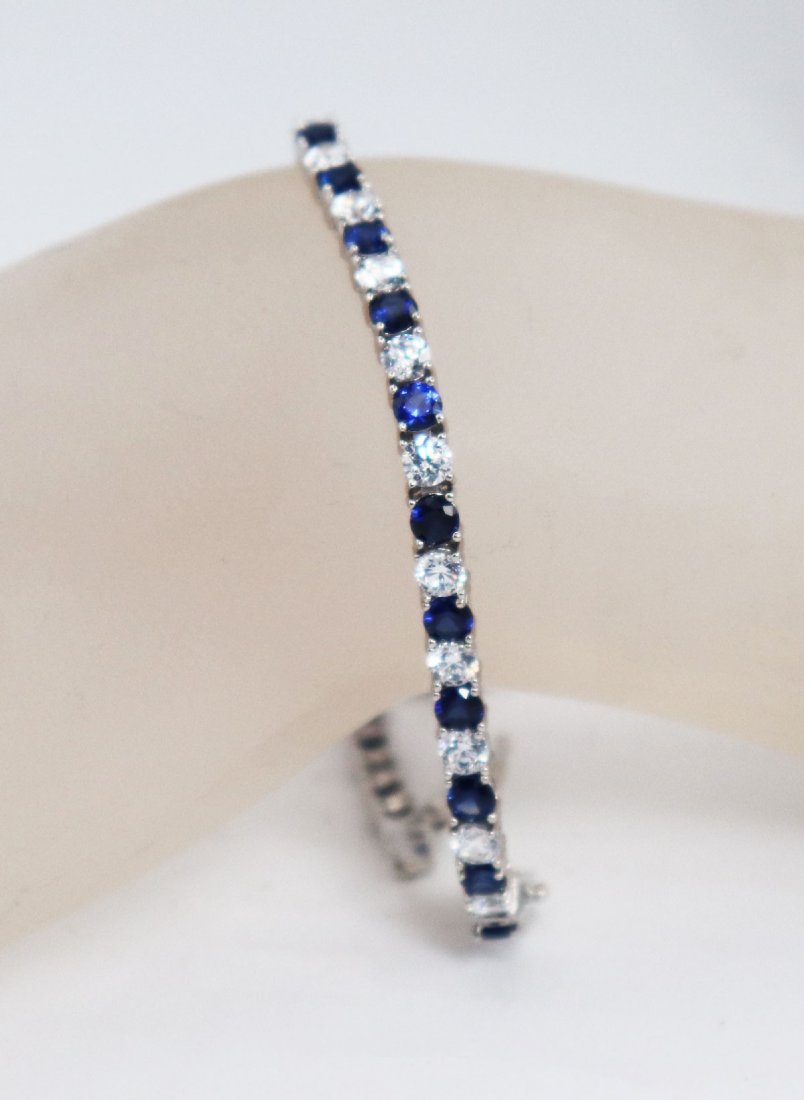 Tennis Bracelet Creation, Diamond & Blue Snappier 18k: Item: Tennis Bracelet White Stone: Approx. 6.25 Carat Round Brilliant Clarity: VS1, Color: F Blue Sapphire: Approx. 6.25 Carat Round Shaped Clarity: Transparent Color: Midnight Blue Metal: 18k white g